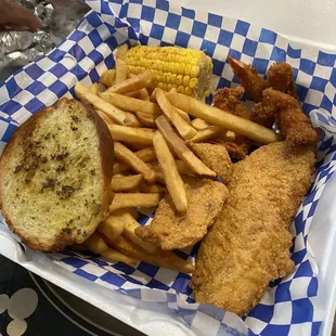 a basket of fried fish and french fries