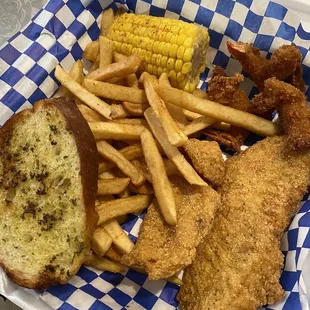 fried fish, fries, corn on the cob and corn on the cob