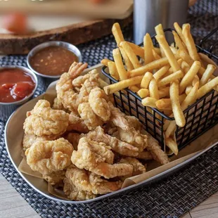 a basket of fries and dipping sauce