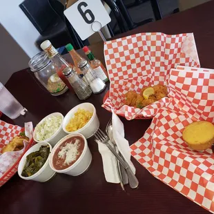 Fried shrimp, fried catfish, bbq chicken. Red beans and rice, mac n cheese, potato salad, greens and corn bread.