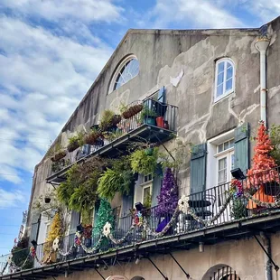 a building with plants on the balconies