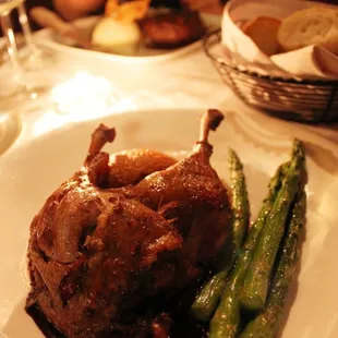 duck confit served with sweet mashed potatoes and asparagus