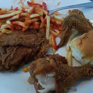a plate of fried chicken, french fries, and ketchup