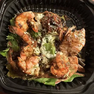 a salad in a styrofoam container