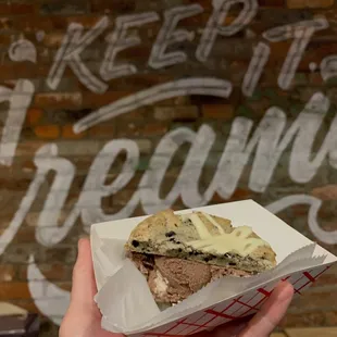 Ice cream sandwich half with malted Oreo cookie dough ice cream and cookies and cream cookie