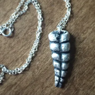 Sterling silver casting of a rattlesnake tail.