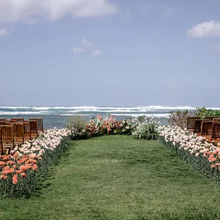 Ceremony area teak chairs &amp; ground florals Emily Turner photography, XO Moreau Planning