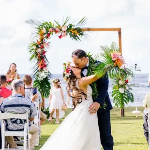 Florals: Ocean Dreamer- arch, Haku lei, bridal &amp; bridal party bouquets, and table center pieces Wedding Coordinator: Ashley Fennel