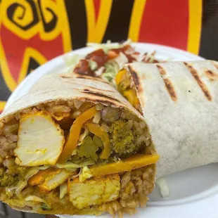 a burrito on a paper plate