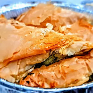 Spanakopites: spinach and feta cheese wrapped in flaky phyllo dough.