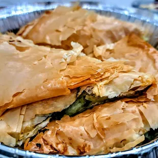 Spanakopites: spinach and feta cheese wrapped in flaky phyllo dough.