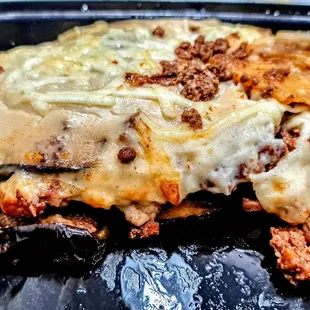 Moussaka: grilled eggplant and potatoes, baked with beef and a bechamel sauce.