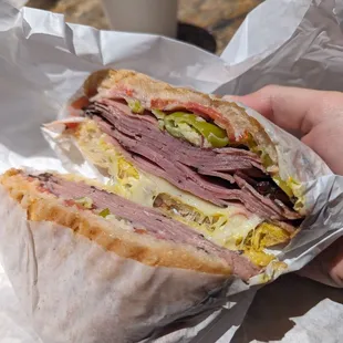 a person holding a sandwich