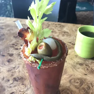 Spicy Bloody Mary with whole strip of crispy bacon is the perfect fore-note for your brunch