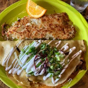 Crepe with mushrooms onions bacon ham Swiss cheese sour cream avocado green onions sprouts and hash browns
