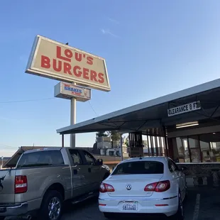 two cars parked in front of a restaurant