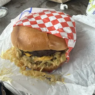 Double cheeseburger with lettuce, onions and sauce.