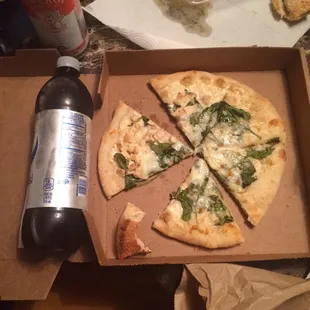 Chicken Alfredo pizza with added spinach. Small. I put the Pepsi next to it for scale.