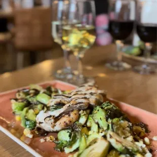 a plate of food and a glass of wine