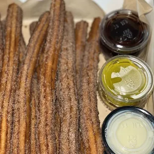 Churros Dozen to go box, with 6 different sauces!