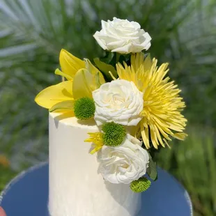 a white cake with yellow flowers