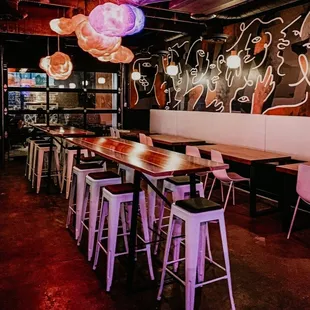 a long table with stools in a restaurant