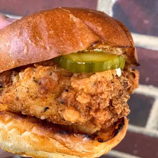 a hand holding a sandwich