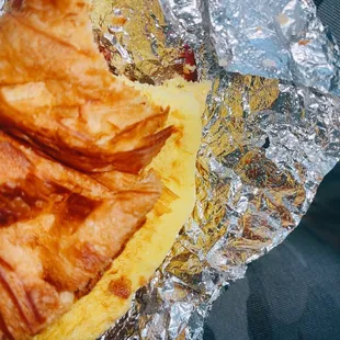 a croissant sandwich wrapped in foil