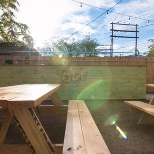 a picnic table and benches in a back yard
