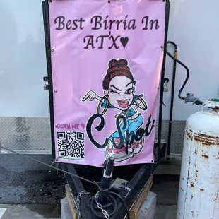 a pink banner with a cartoon character on it