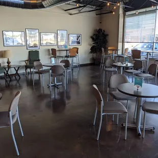Large cafe Picture shows multiple tables and chairs, with walk and wheel space between. Upon entering seating is to your right.