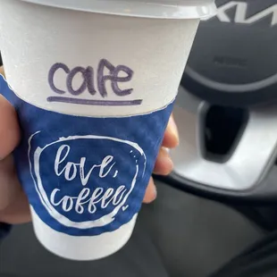 a hand holding a cup of coffee