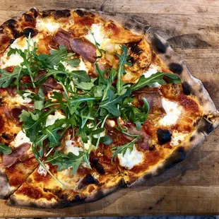 Fancy That- Fresh gourmet Burrata together with crispy fired prosciutto and finished with arugula.