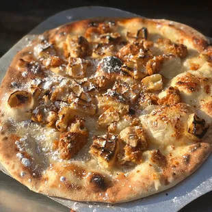 The Perfect Pair- Crispy Chicken, toasted waffle bits, shredded mozzarella, topped with maple syrup, and sprinkled with powdered sugar