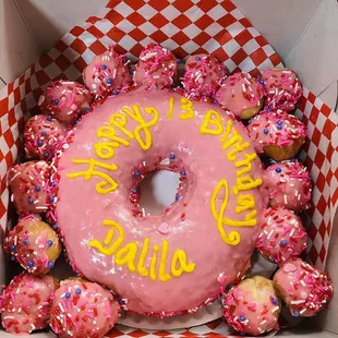 a pink donut with sprinkles