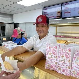 Owner passing out reach donuts