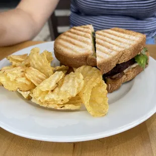 a sandwich and chips on a plate