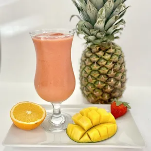 a pineapple, orange juice, and sliced fruit