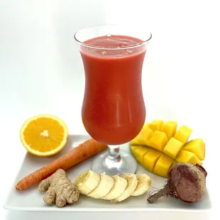 a glass of juice and sliced vegetables