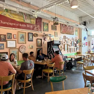 people sitting at tables in a restaurant
