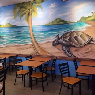 a mural of a turtle on the beach