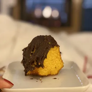 a chocolate frosted donut on a plate