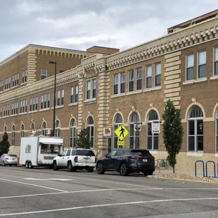 cars parked in front of a brick building
