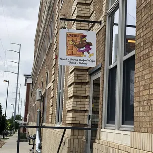 a brick building with a sign on it