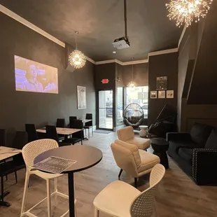 a living room with chairs and tables