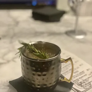 a mug with a sprig of rosemary