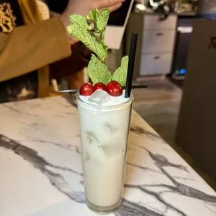 Winter Wonderland - rum, lime, sugar cube, mint, lime juice, coconut milk, coconut simple, club soda, cranberry/mint garnish