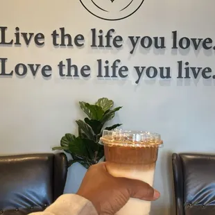 a hand holding a cup of coffee