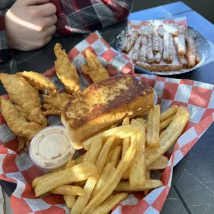 a basket of french fries and a sandwich