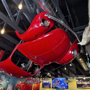 a red car suspended from the ceiling